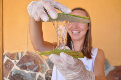 Portrait of a smiling young woman holding ice cream