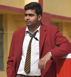 Young man in uniform standing at university