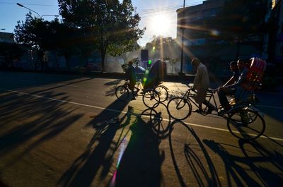 People riding bicycle on road in city