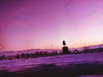 Silhouette of woman in city at night