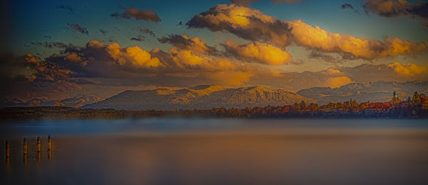 Scenic view of lake against sky at sunset