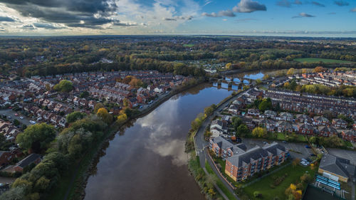 High angle view of cityscape by sea against sky