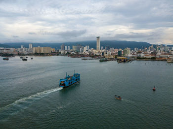 High angle view of buildings by sea against sky