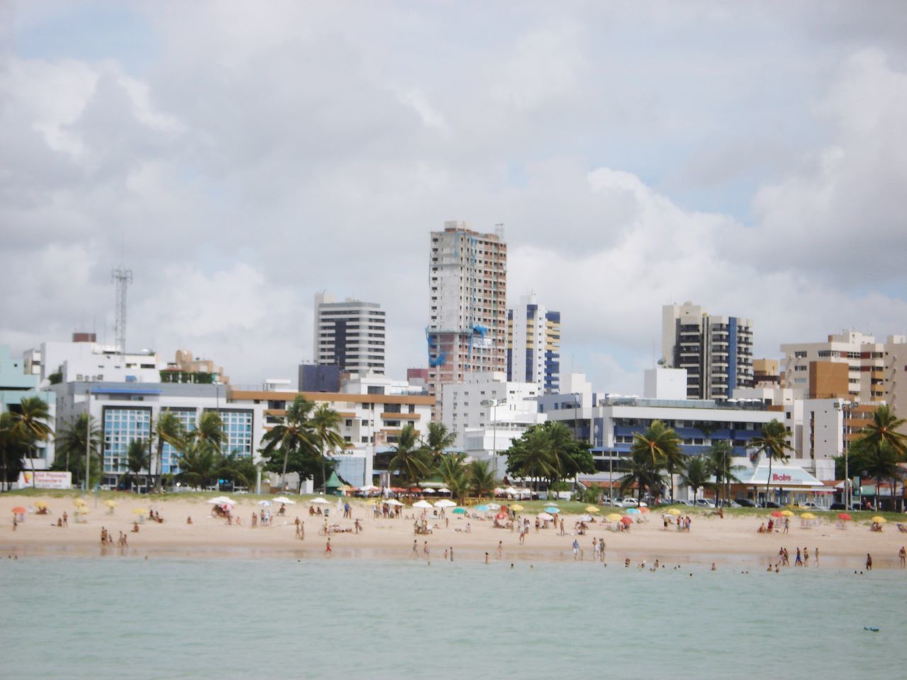 PANORAMIC VIEW OF BEACH BY BUILDINGS AGAINST SKY IN CITY