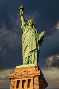 Low angle view of statue against cloudy sky