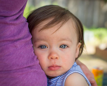 Close-up portrait of cute crying girl embracing mother