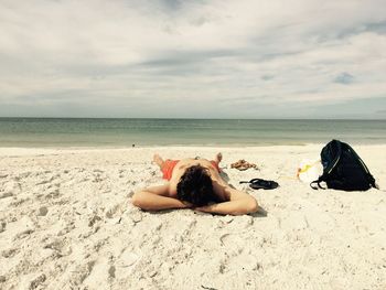 Man is sunbathing on the beach 