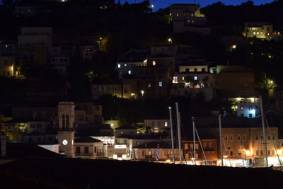 Illuminated cityscape against sky at night