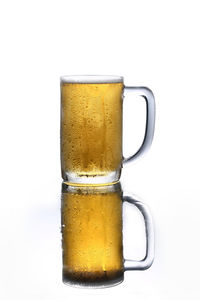 Close-up of beer glass against white background