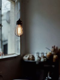 Illuminated electric lamp on table at home