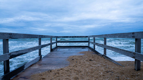 Pier over sea against sky