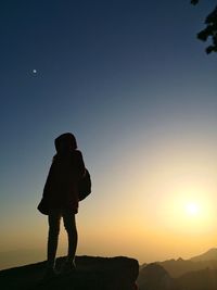 Silhouette of woman standing on landscape