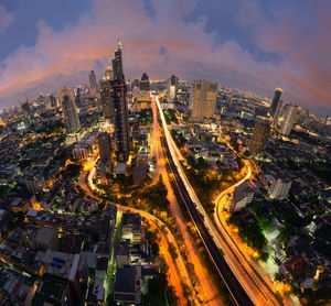 High angle view of city lit up at night