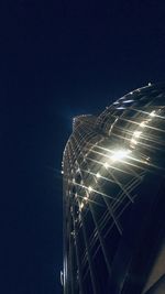 Low angle view of illuminated building against sky at night