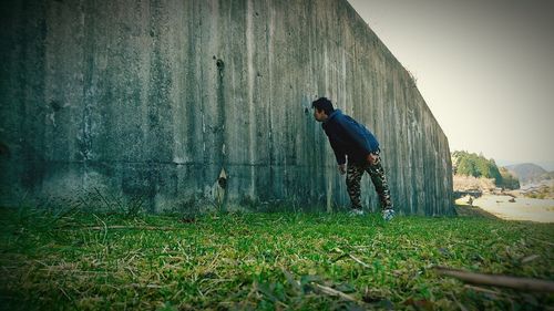 Man skateboarding on grass