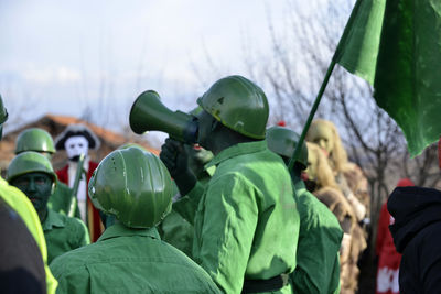 People in costumes against sky