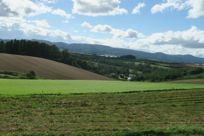 Scenic view of farm against sky