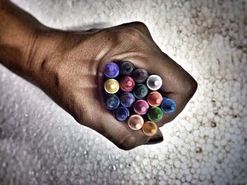 Cropped hand holding colorful crayons