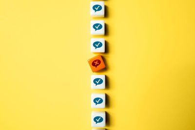 Close-up of toy blocks on yellow background