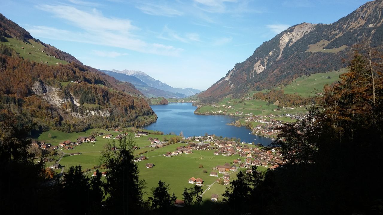 mountain, water, mountain range, scenics, tranquil scene, tranquility, beauty in nature, tree, sky, lake, nature, idyllic, river, non-urban scene, blue, outdoors, day, landscape, cloud, sunlight