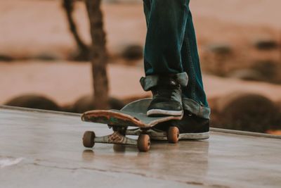 Low section of man skateboarding outdoors