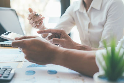 Midsection of woman working on table