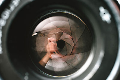 Reflection of man photographing in mirror