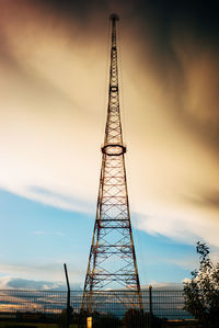 Low angle view of communications tower against sky