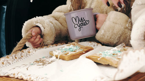 Winter tea picnic. close-up. tasty snack, tea party outdoors, in snowy forest, during snowfall. 