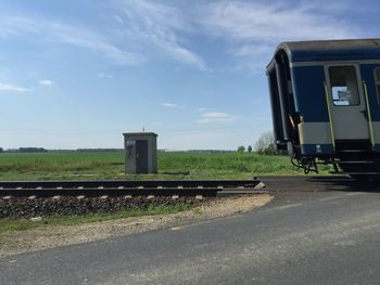 Old train on railroad tracks against sky