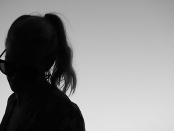 Rear view of woman standing against white background
