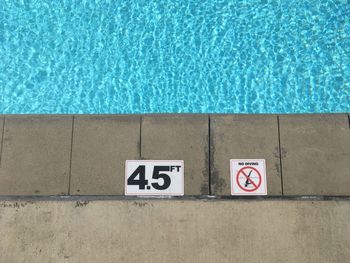 No diving sign and number on poolside