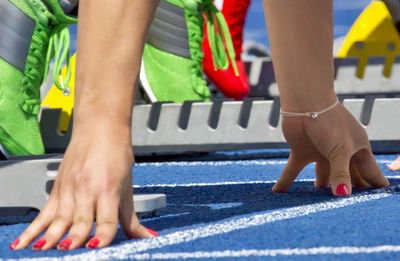 Low section of people at starting block on running track