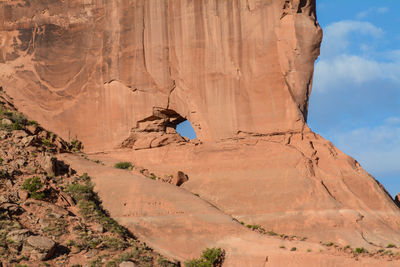 Low angle view of man on cliff against sky