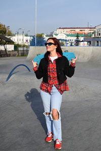 Full length of young woman standing on street