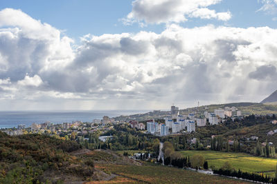 Panoramic view of townscape by sea against sky