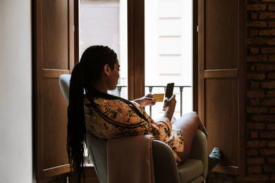 Woman sitting on chair at home