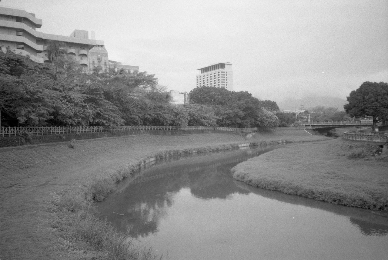 architecture, black and white, water, tree, built structure, plant, sky, building exterior, nature, monochrome photography, monochrome, river, building, waterway, no people, city, history, outdoors, travel destinations, the past, day, environment, reflection