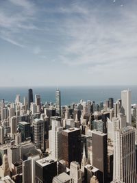 Aerial view of city against cloudy sky