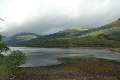 Scenic view of lake and mountains against sky