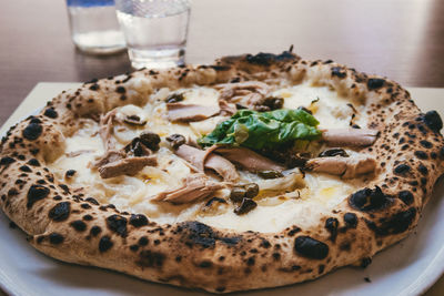 High angle view of pizza served on table