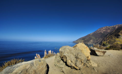 Scenic view of sea against clear blue sky