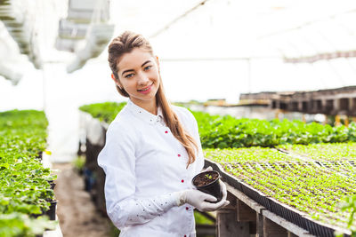 Portrait of smiling young woman standing outdoors