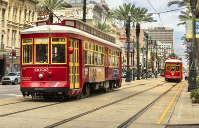 View of railroad tracks by street in city