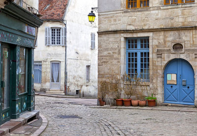 Empty street amidst buildings in city