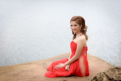 Portrait of young woman sitting outdoors