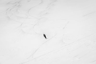 High angle view of person skiing on snowcapped field