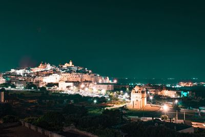 High angle view of illuminated buildings in city at night