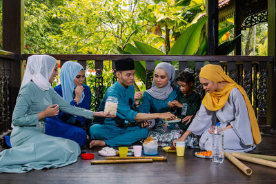 Rear view of people sitting in traditional clothing