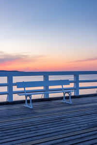 Pier over sea against sky during sunset